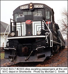 FGLK B23-7 #2303 idles awaiting passengers at the old NYC depot in Shortsville.  Photo by Michael C. Smith.